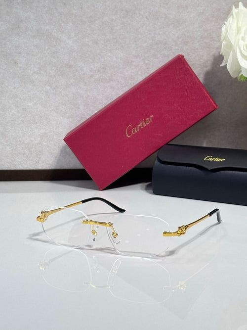 Gold-tone eyeglasses with clear lenses and sculpted metal temple details