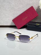 Gold-tone sunglasses with blue-tinted lenses and decorative metal temple arms