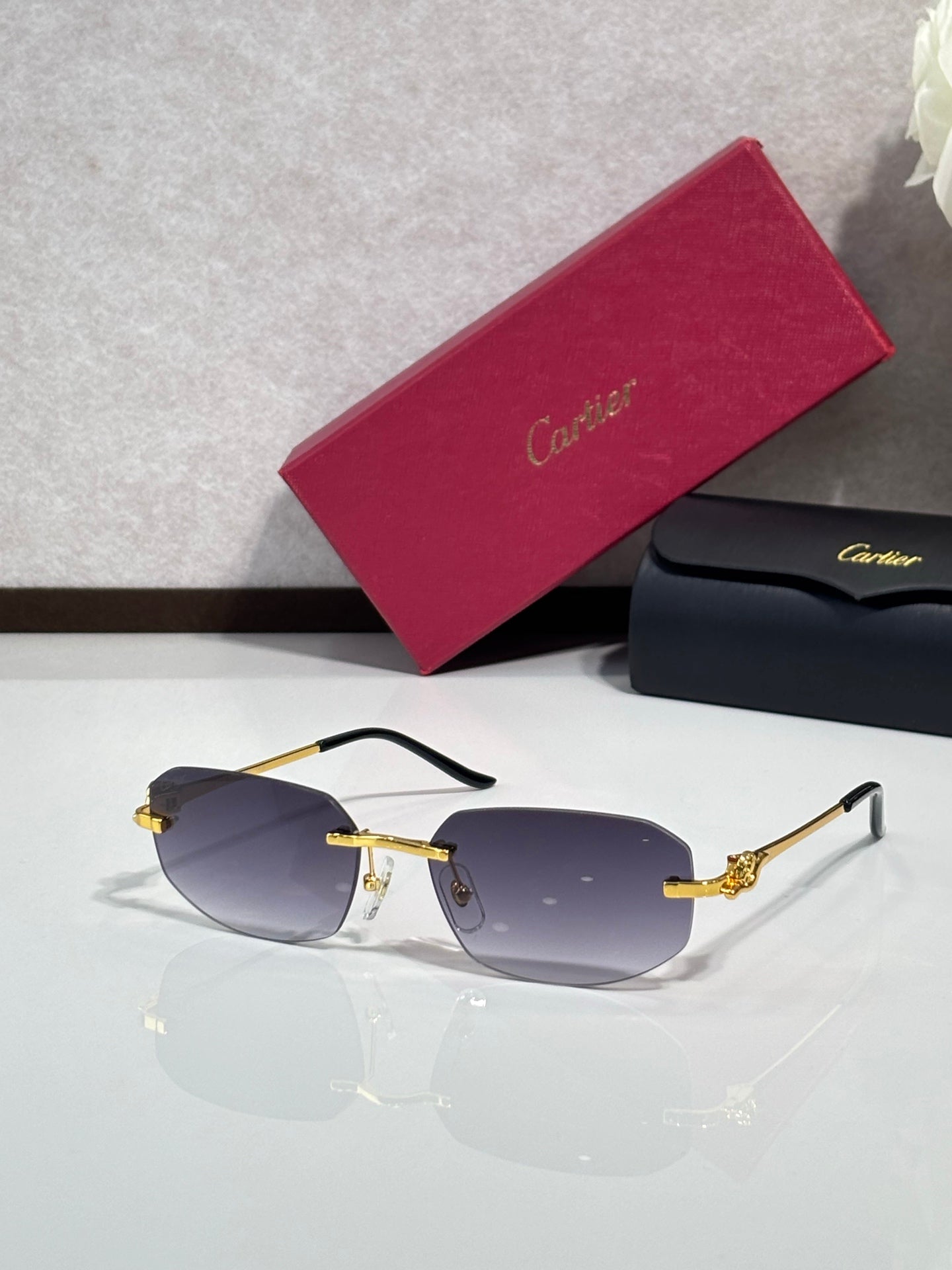 Gold-tone sunglasses with blue-tinted lenses and decorative metal temple arms