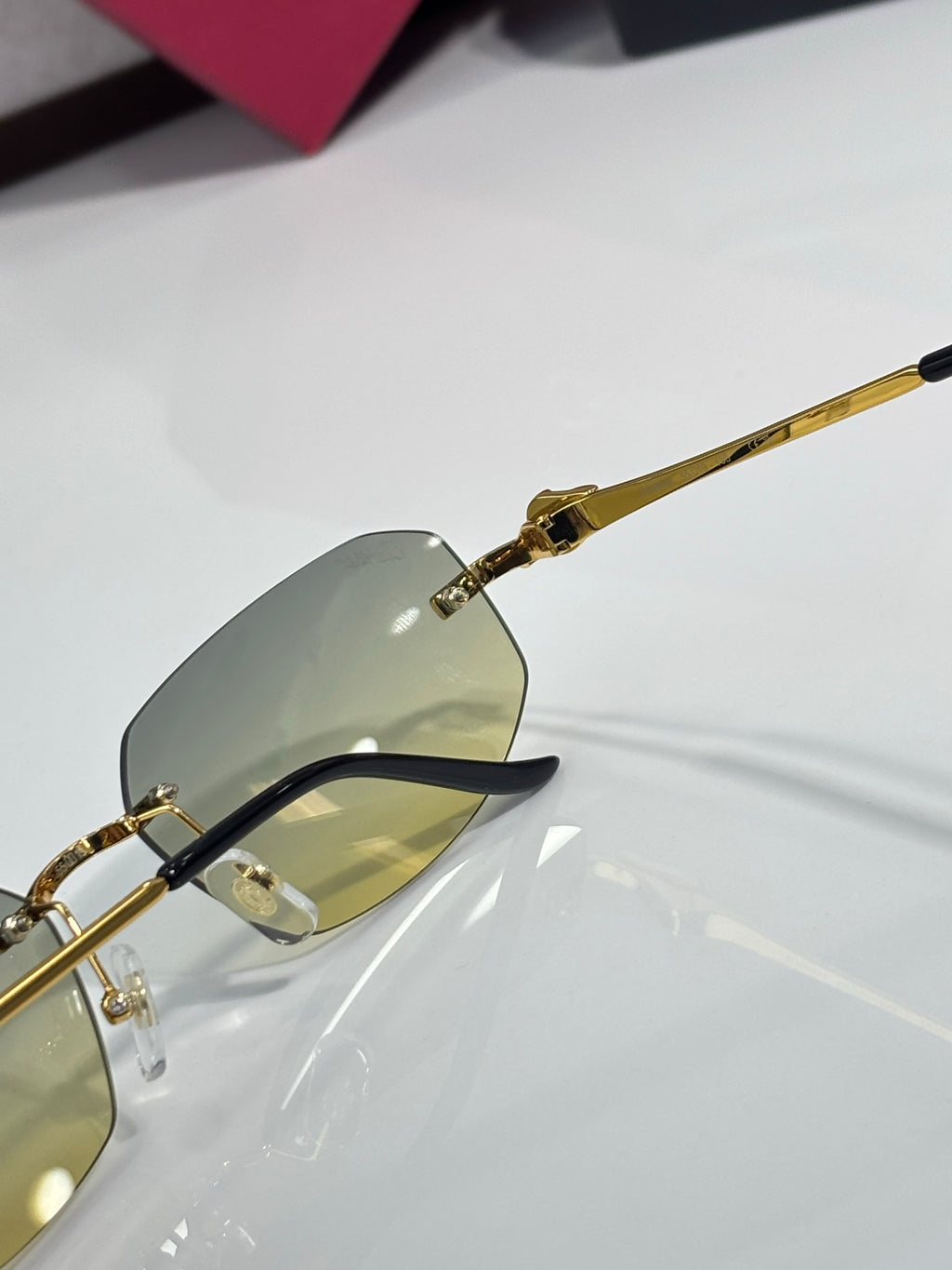 Cartier sunglasses close-up of lens and gold bridge with light amber tint