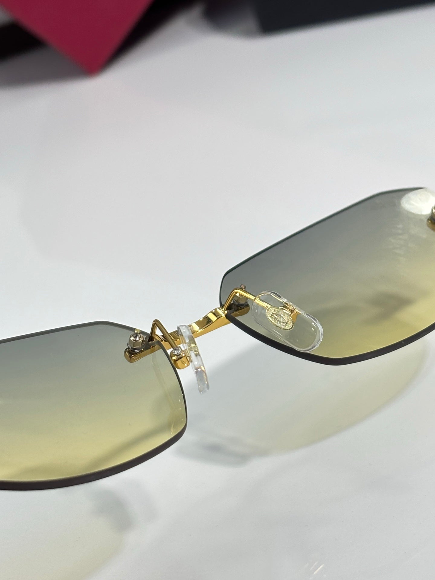 Cartier sunglasses close-up of gold hinge and light amber tinted lenses