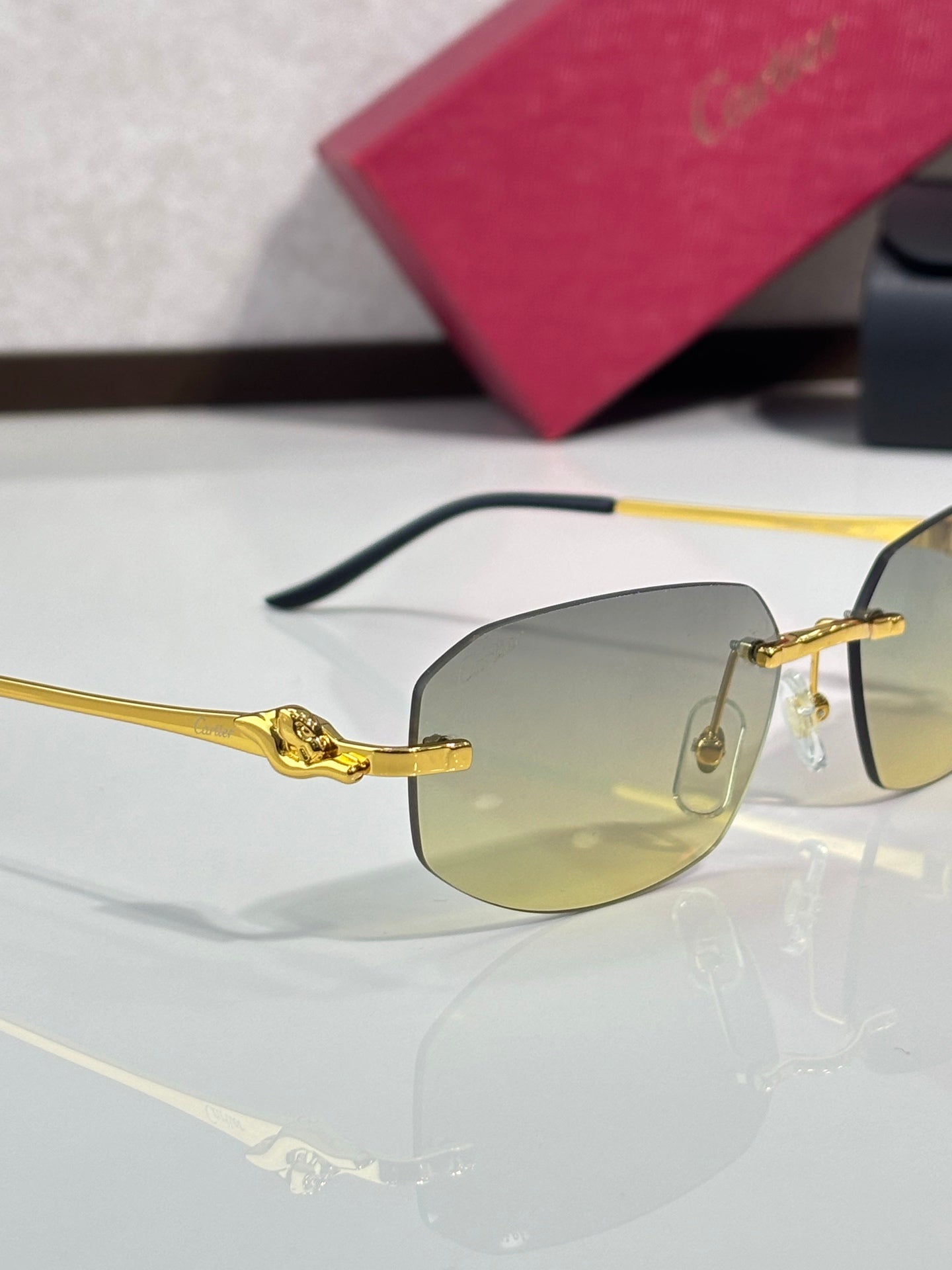 Cartier sunglasses side view: gold frame with light amber lenses and dark temple arms