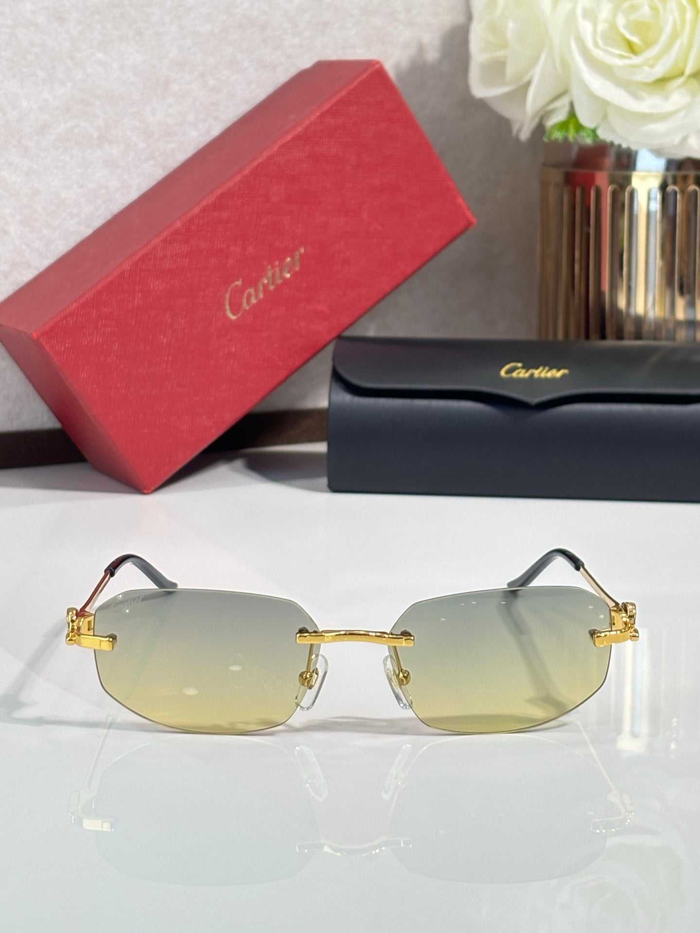 Cartier sunglasses, gold rim and hinges, clear-to-light amber lenses with dark temples