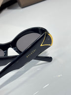 BVLGARI sunglasses with dark lenses, black frame and gold-trimmed temple end