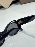 BVLGARI sunglasses showing gold-tone hinge detail on glossy black temples