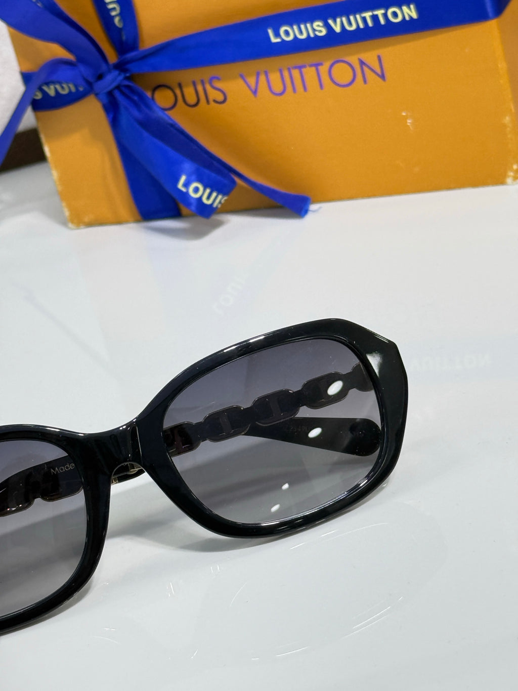 Sunglasses side view with glossy black frame and tinted lens