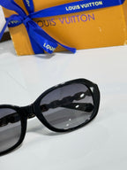 Sunglasses side view with glossy black frame and tinted lens