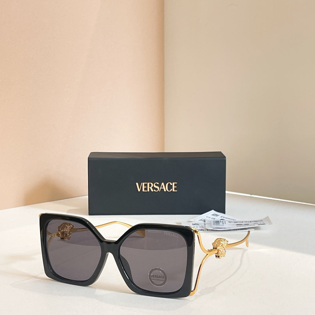 Versace sunglasses, black square frames with gold Medusa temple detail, tinted lenses