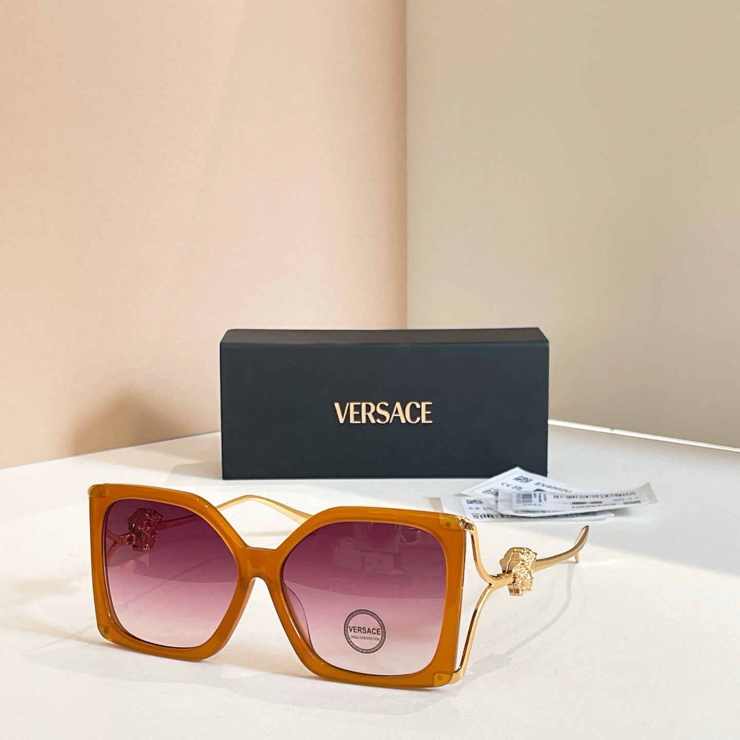 Versace sunglasses, orange square frames with gold Medusa temple detail, tinted lenses