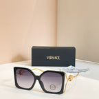 Versace sunglasses, black square frames with gold Medusa temple detail, tinted lenses