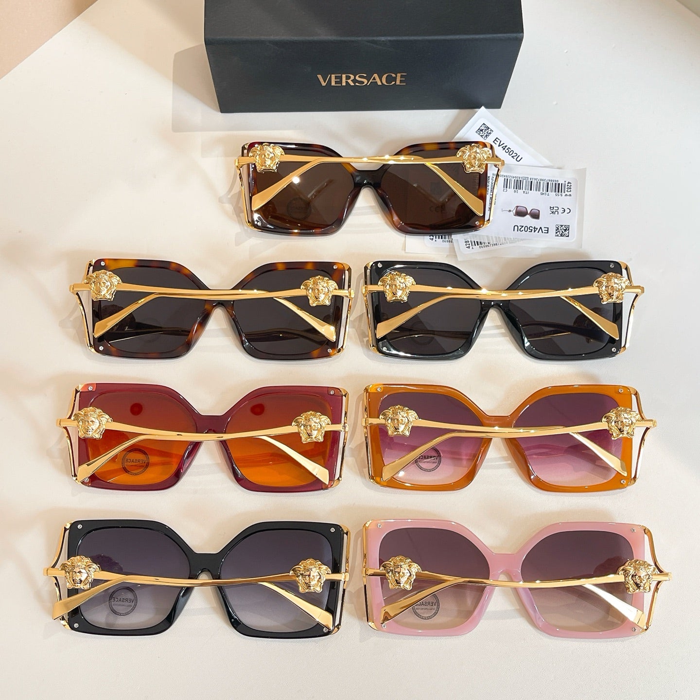 Versace sunglasses assortment with tortoise, red, orange, black, and pink frames, gold temples