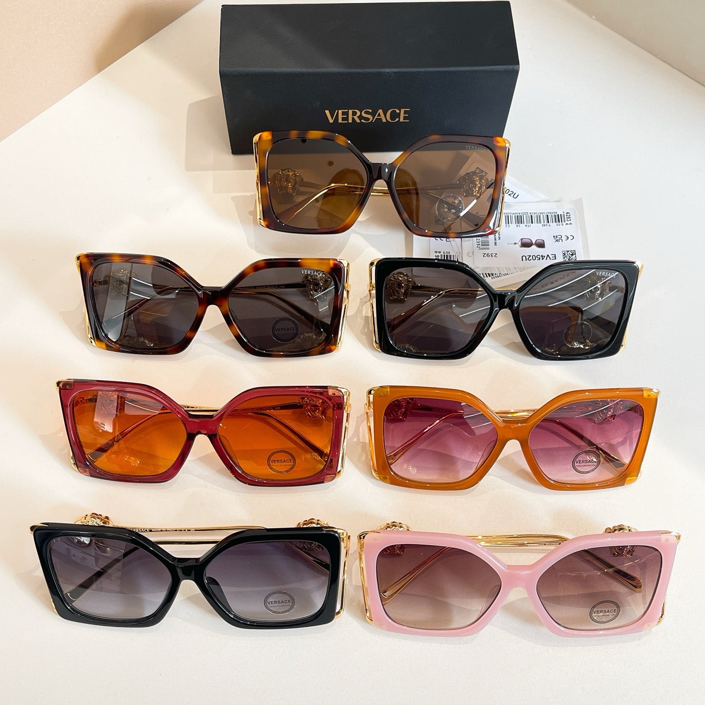 Versace sunglasses assortment with varied square frames and gold temples, tinted lenses