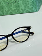 Gucci eyeglasses close-up side view with black frame and gold hinge