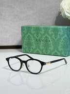 Gucci eyeglasses with black acetate frames and gold-trim arms