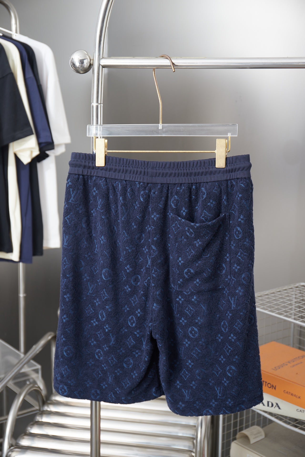 Navy patterned drawstring shorts with elastic waistband, front view