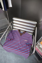 Prada striped polo shirt on rack, light blue with red stripes and chest pocket