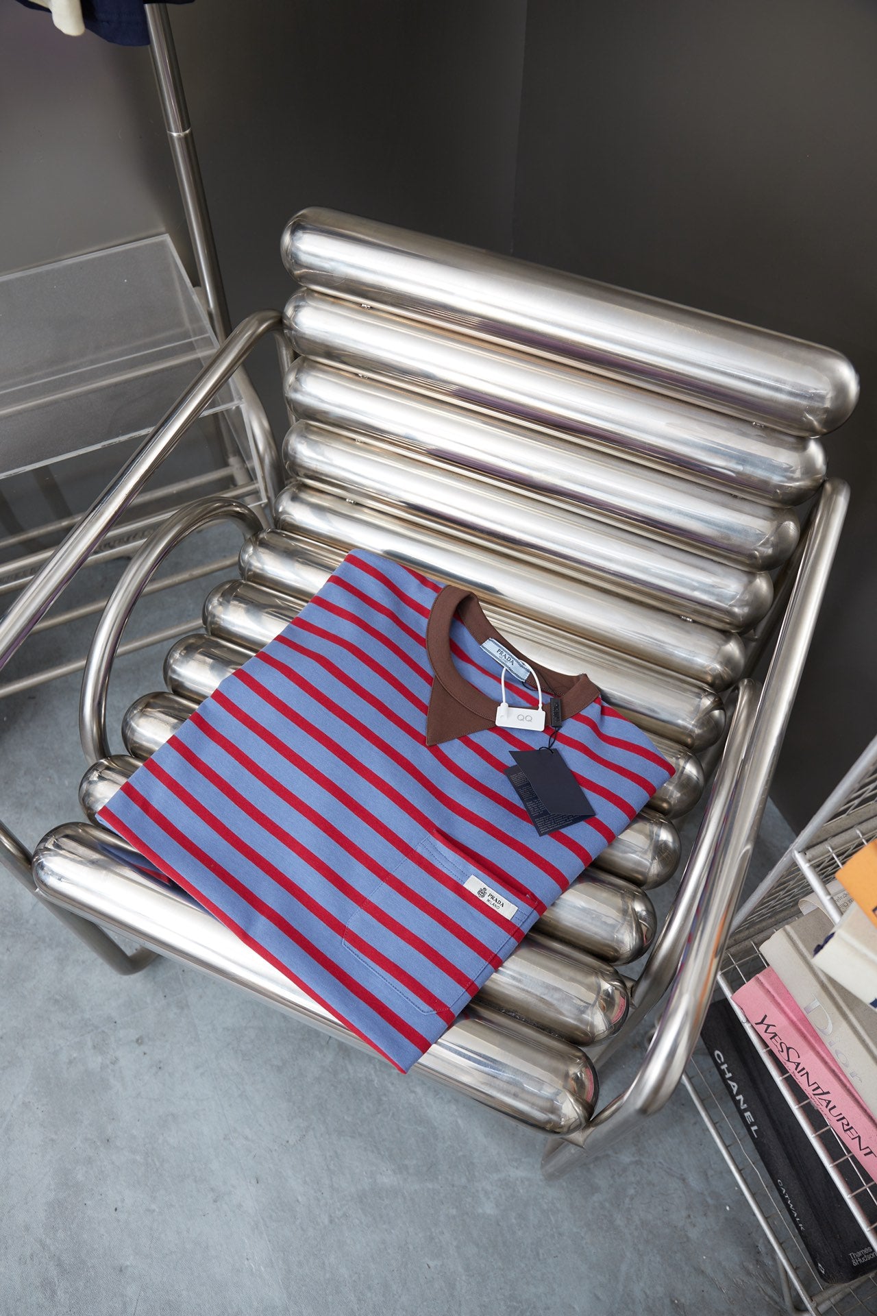 Prada striped polo shirt on rack, light blue with red stripes