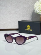 Versace purple sunglasses with pink lenses and gold logo on temple