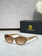Versace beige sunglasses with brown lenses and metallic logo accents