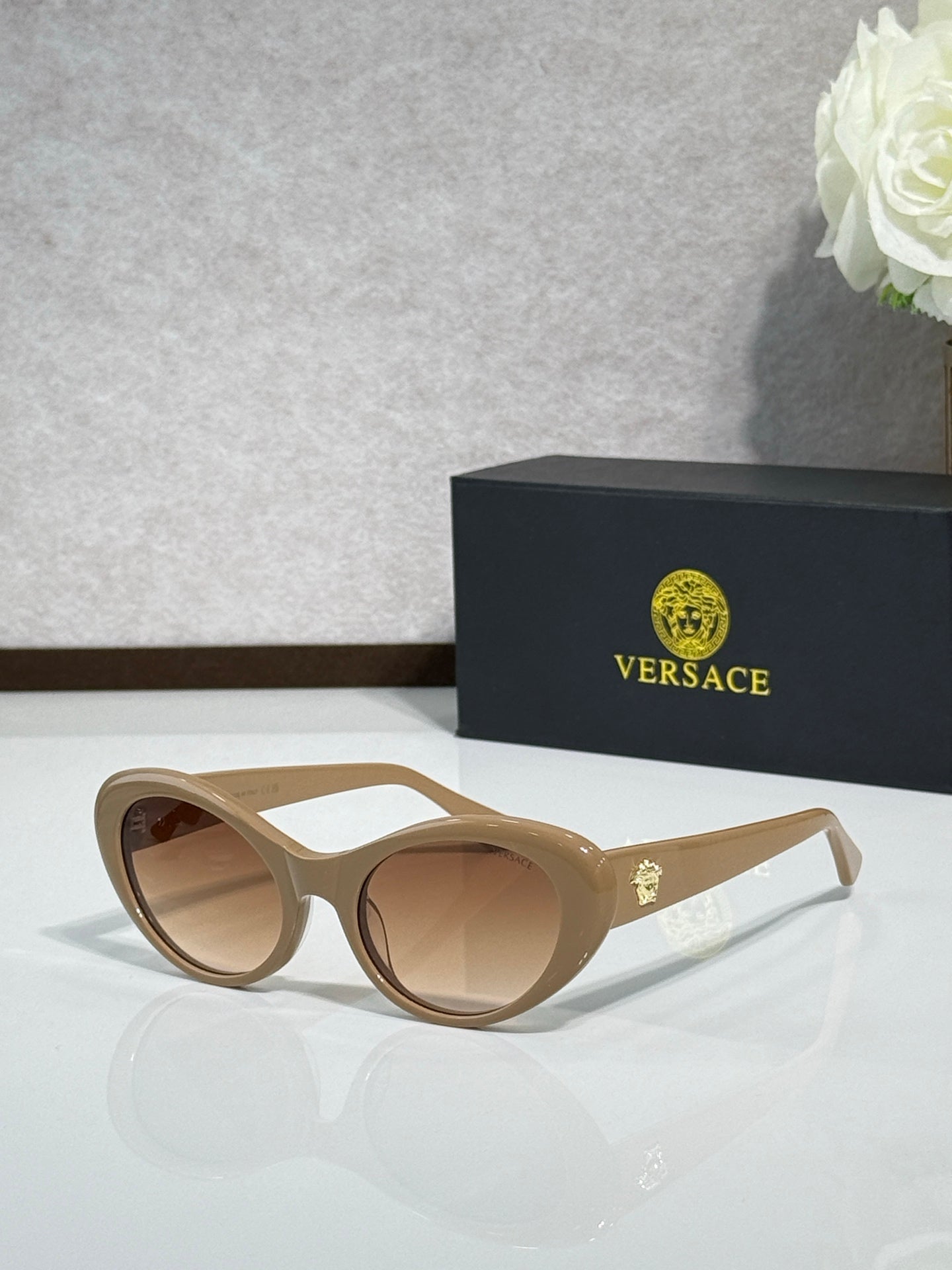 Versace beige sunglasses with brown lenses and metallic logo accents