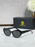 Versace black round sunglasses with dark lenses and white temple tips