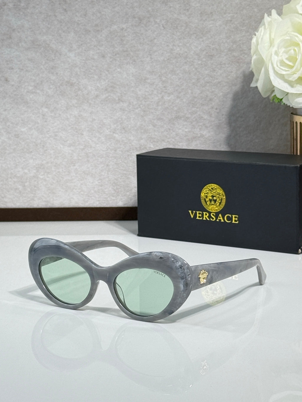 Versace sunglasses with gray round frames and light green lenses