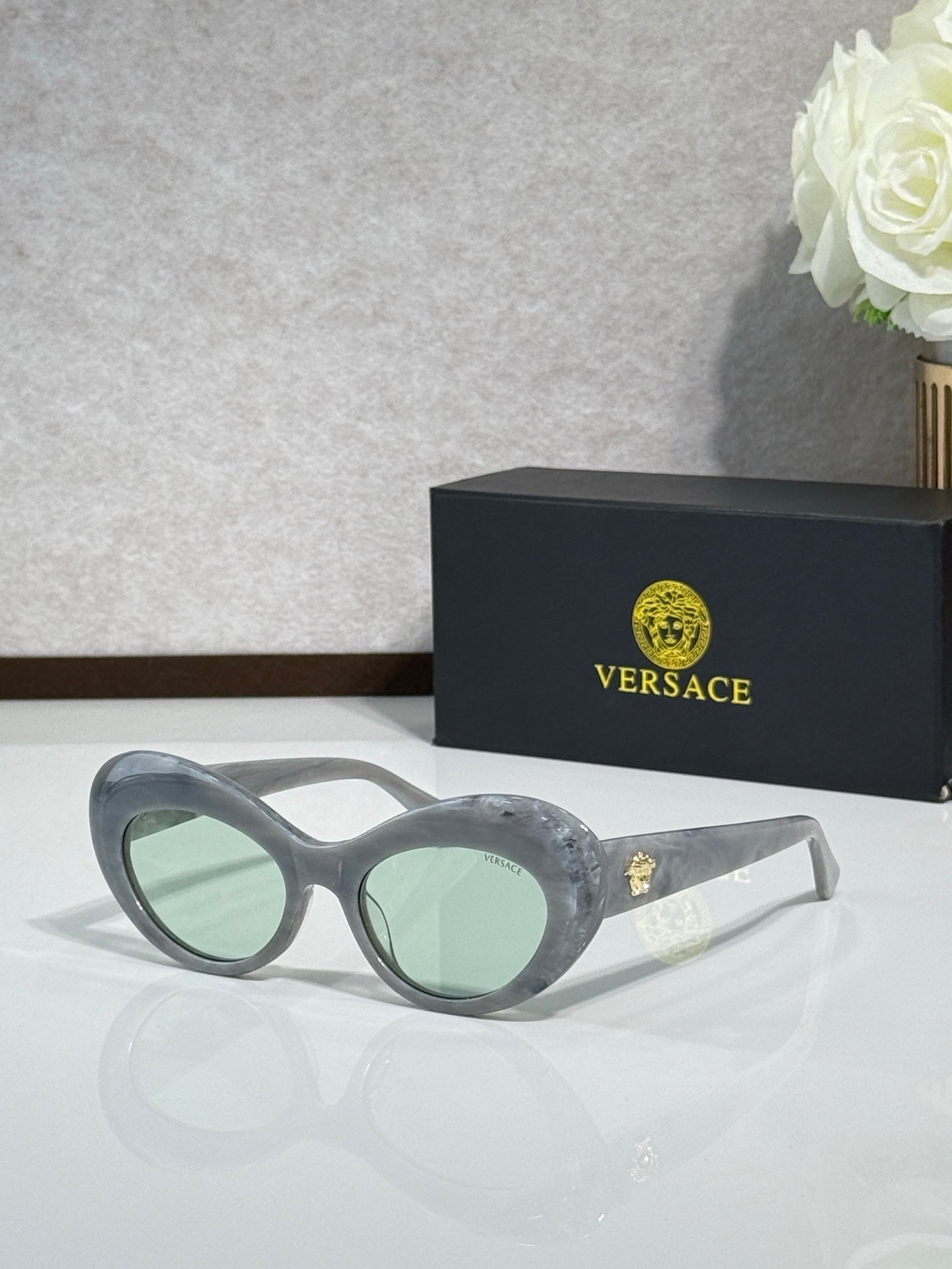 Versace sunglasses with gray round frames and light green lenses