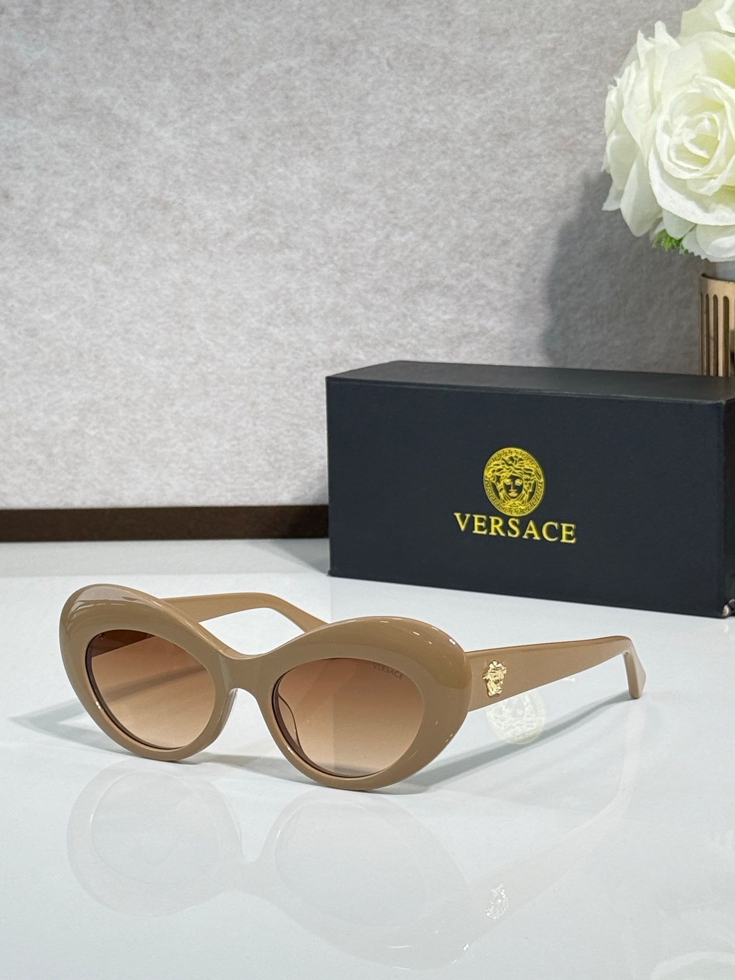 Versace sunglasses with beige round frames and tan lenses