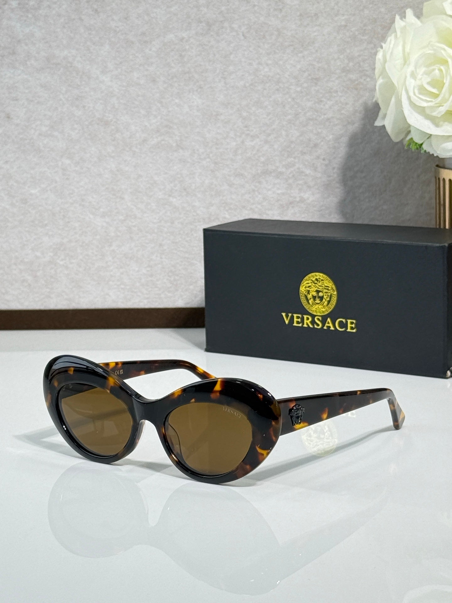 Versace sunglasses with black frames and brown gradient lenses