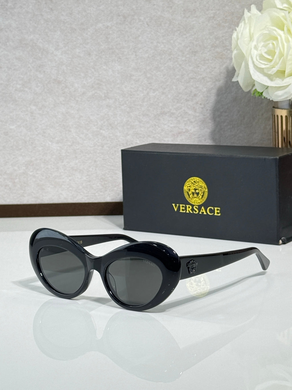 Versace sunglasses with black round frames and dark lenses