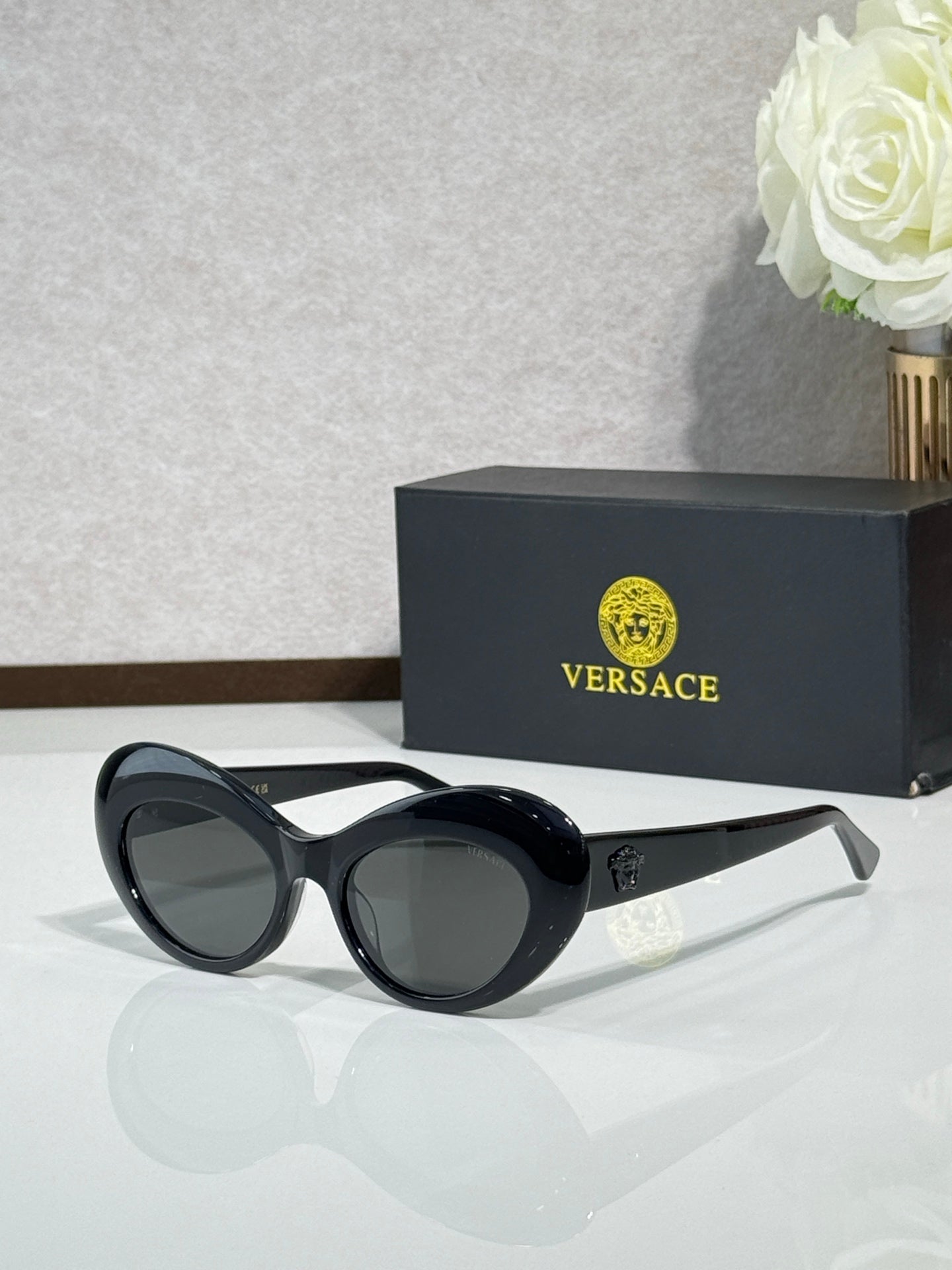 Versace sunglasses with black round frames and dark lenses