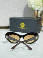 Versace sunglasses with dark brown frames and amber lenses