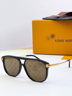 Sunglasses with black frames, LV monogram lens panels, and warm brown lenses
