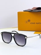 Sunglasses with black frames and dark lenses, gold-tone metal accents