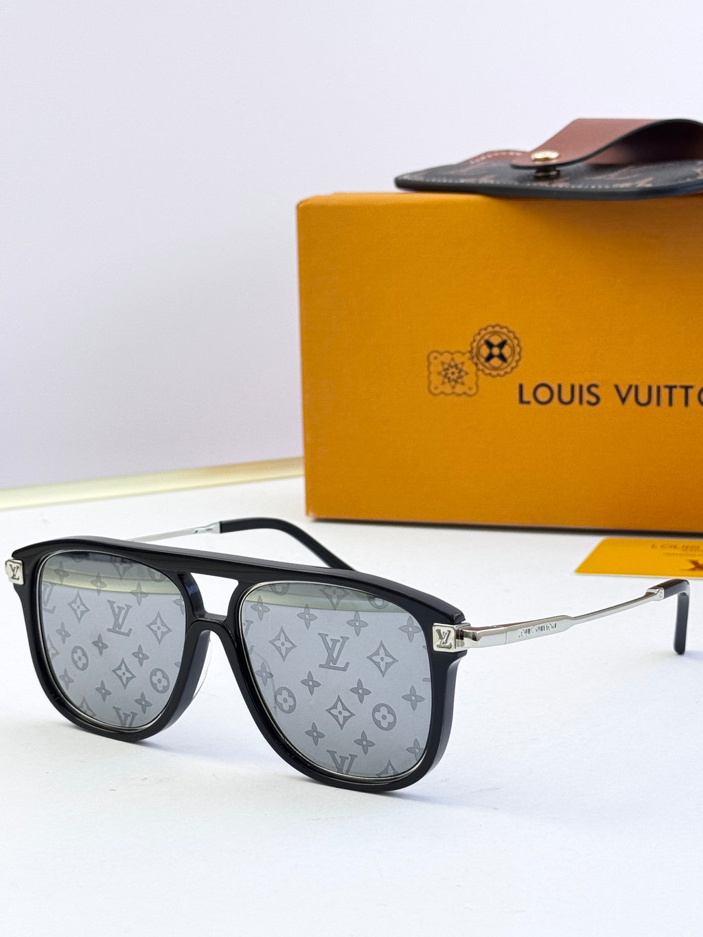 Sunglasses with black frames and LV monogram lens panels, dark tinted lenses