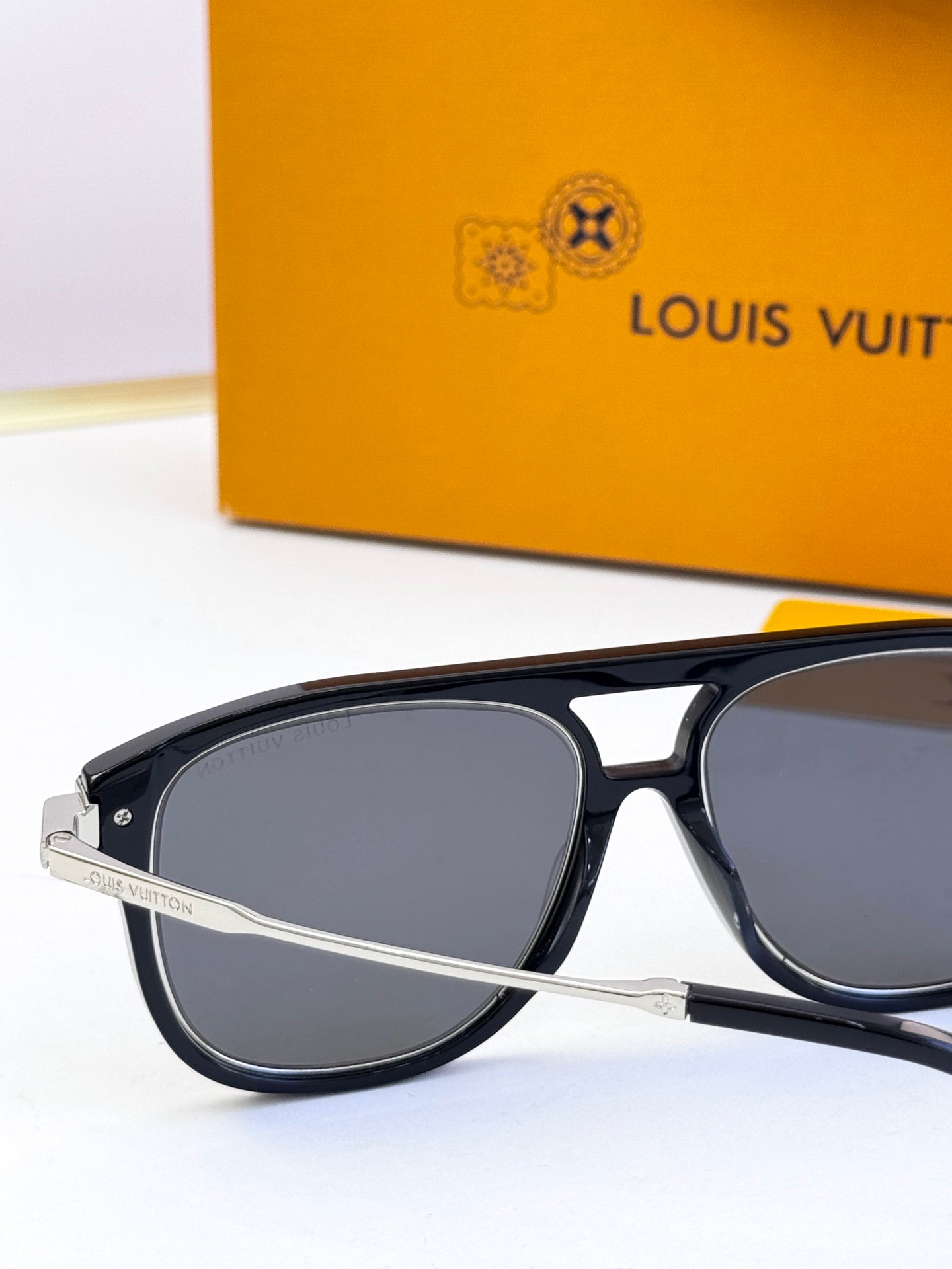 Sunglasses close-up with black frames and dark lenses, silver-tone arms