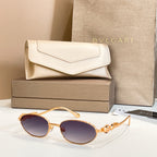 Bvlgari sunglasses with round dark lenses and gold-tone frames, shown with case