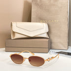 Bvlgari sunglasses with round brown lenses and gold-tone frames, shown with case