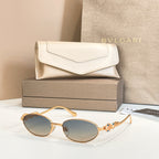 Bvlgari sunglasses with round dark lenses and gold-tone frames, shown with case
