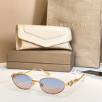Bvlgari sunglasses with round light lenses and gold-tone frames, shown with case