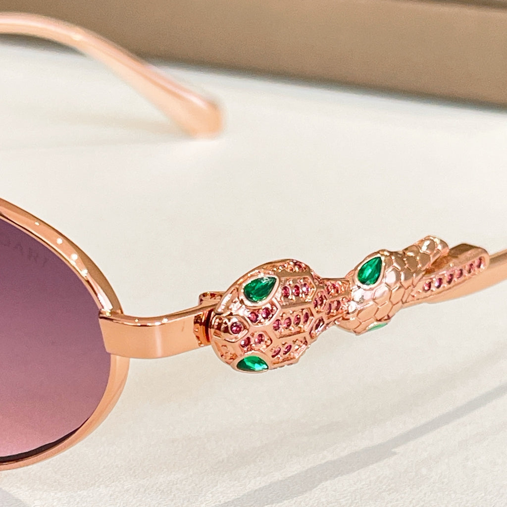Gold-tone sunglasses hinge with colorful gemstone detailing and round lens edge