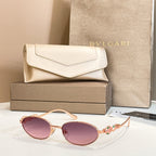 Bvlgari sunglasses with round rose-tinted lenses and gold-tone frames, shown with case