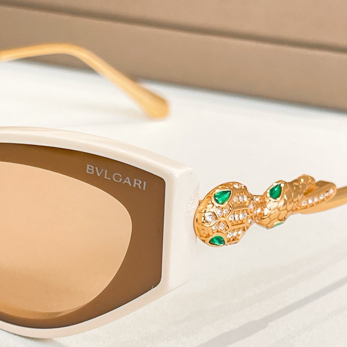 Bvlgari cat-eye sunglasses, white frame with gold arm detail and lens