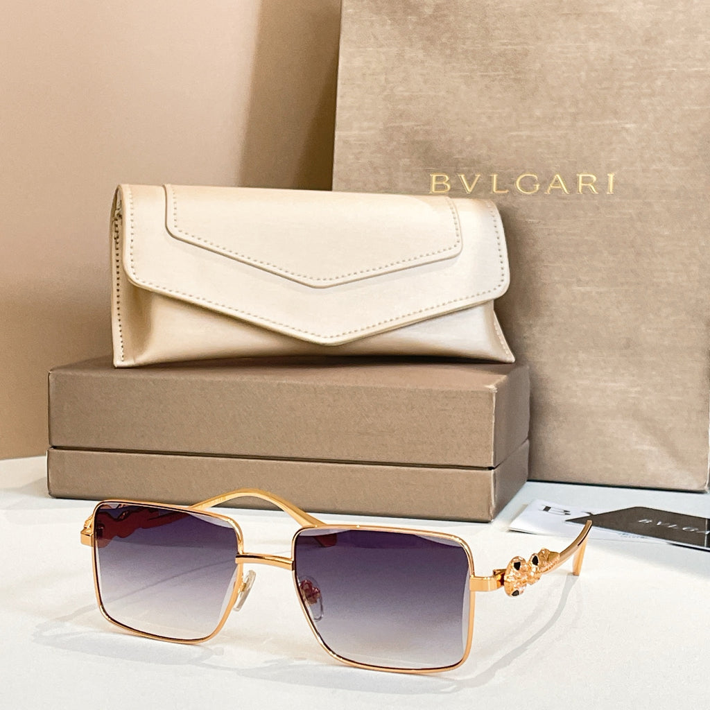 Gold-framed square sunglasses with violet gradient lenses and jeweled side ornament