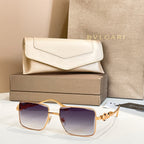 Gold-framed square sunglasses with violet gradient lenses and jeweled side ornament