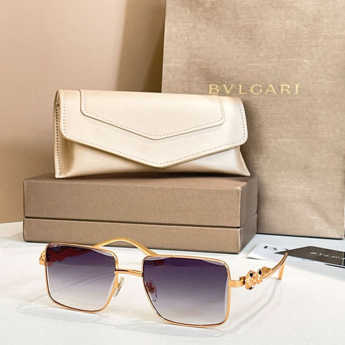 Gold-framed square sunglasses with violet gradient lenses and jeweled side ornament