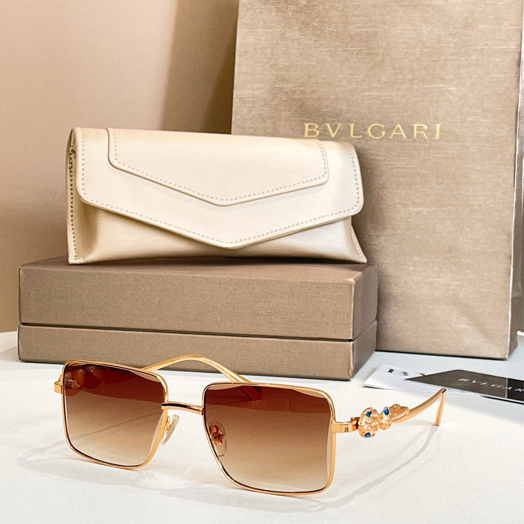 Gold-framed square sunglasses with warm amber gradient lenses and jeweled temple detail