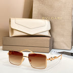 Gold-framed square sunglasses with warm amber gradient lenses and jeweled temple detail