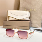 Gold-framed square sunglasses with pink gradient lenses and decorative temple details