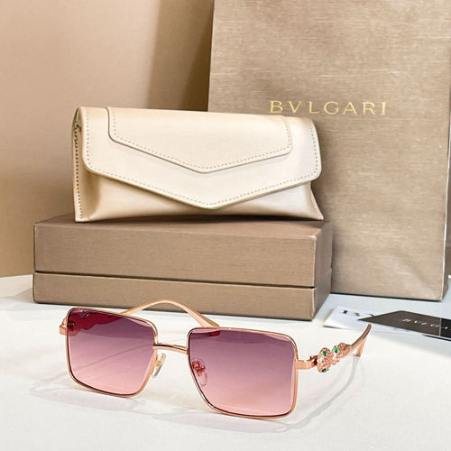 Gold-framed square sunglasses with pink gradient lenses and decorative temple details